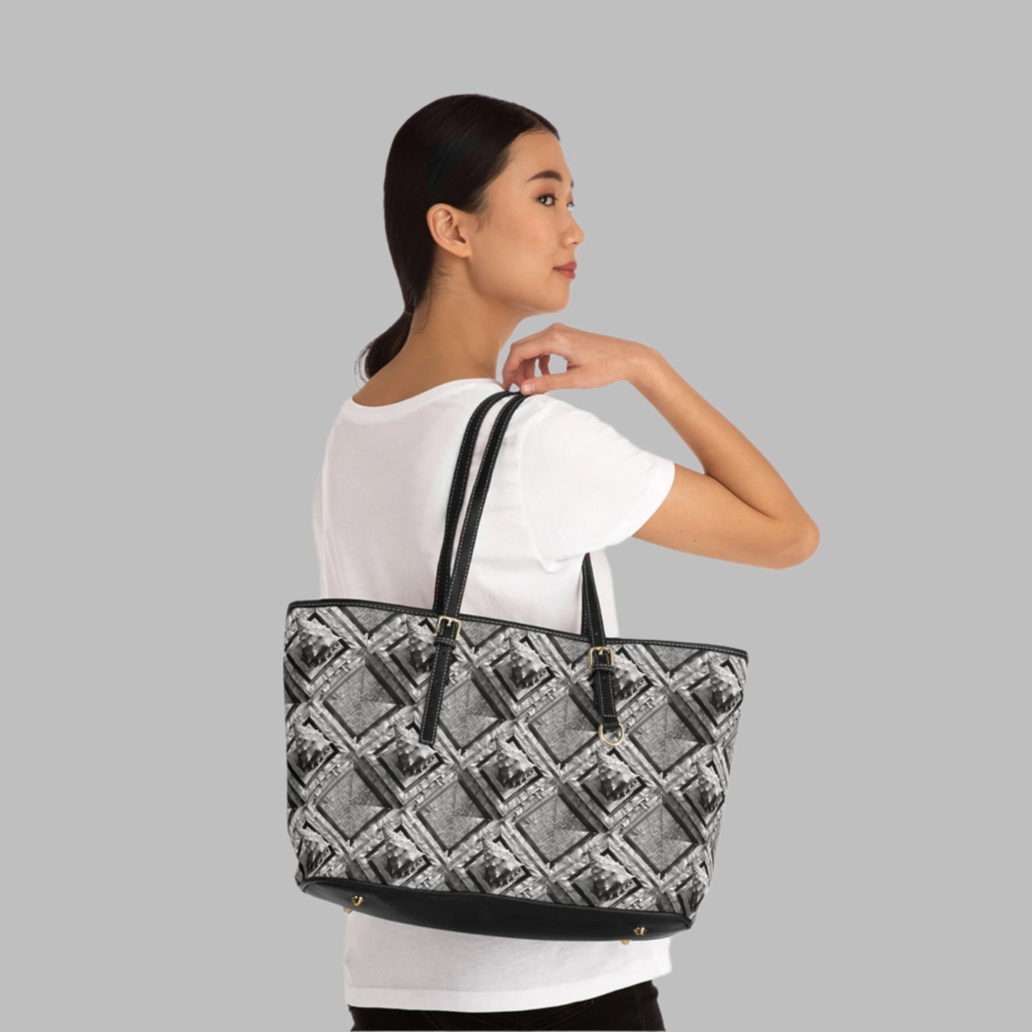 Polynesian-Inspired Chic Leather Shoulder Bag with Conch Shell Design being held over the shoulder of a person side view