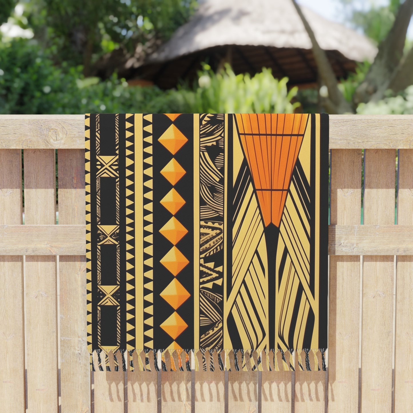 Polynesian-Inspired Boho Beach Towel hanging over a fence side view