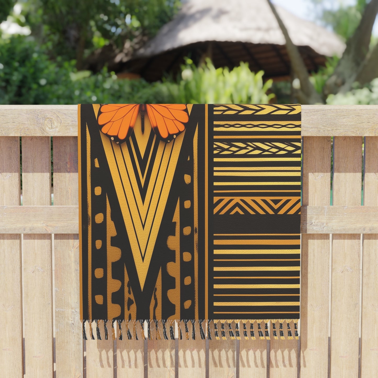 Polynesian-Inspired design Boho Beach Towel with butterfly illustration graphic hanging on a fence close up view
